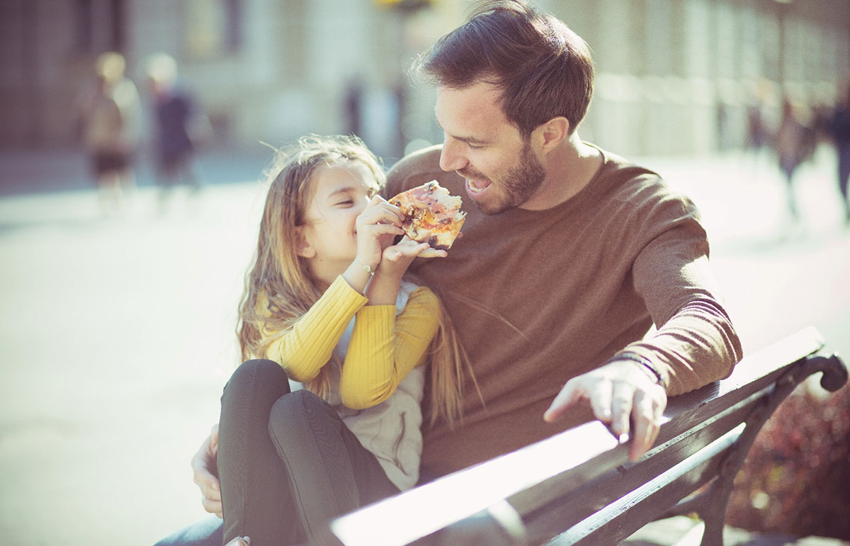 Father daughter eating pizza