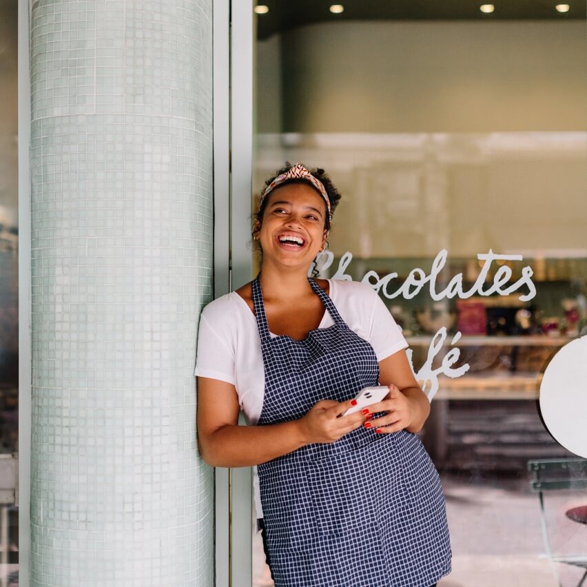 Smiley girl is front of coffee shop